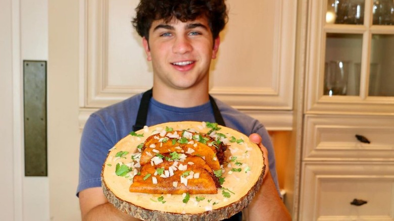 Matthew Merril holding meal he made