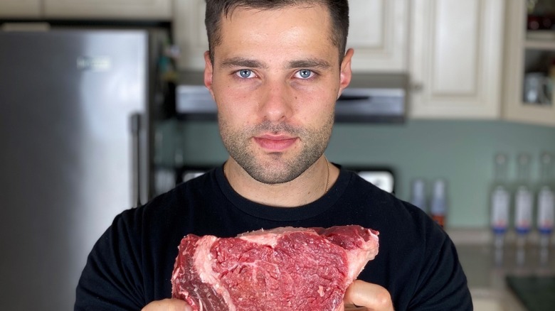 Max Greb holding steak