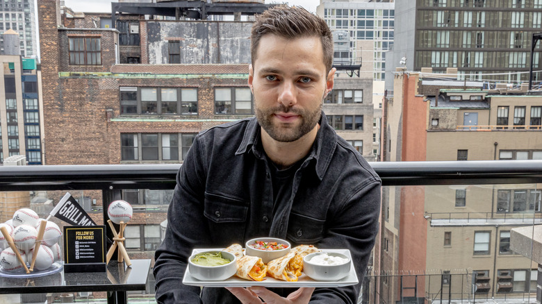 Max the Meat Guy holding plate of Mexican food