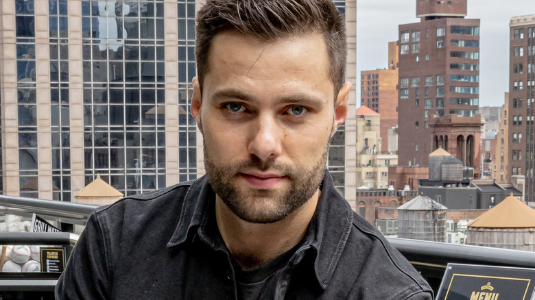 Max Greb posing on city balcony