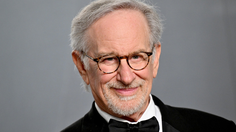 Steven Spielberg posing in a tuxedo.