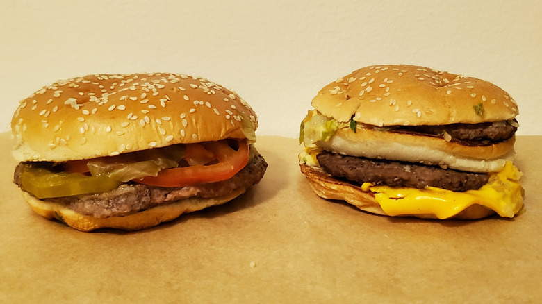 a Burger King Whopper and a McDonald's Big Mac side by side on counter