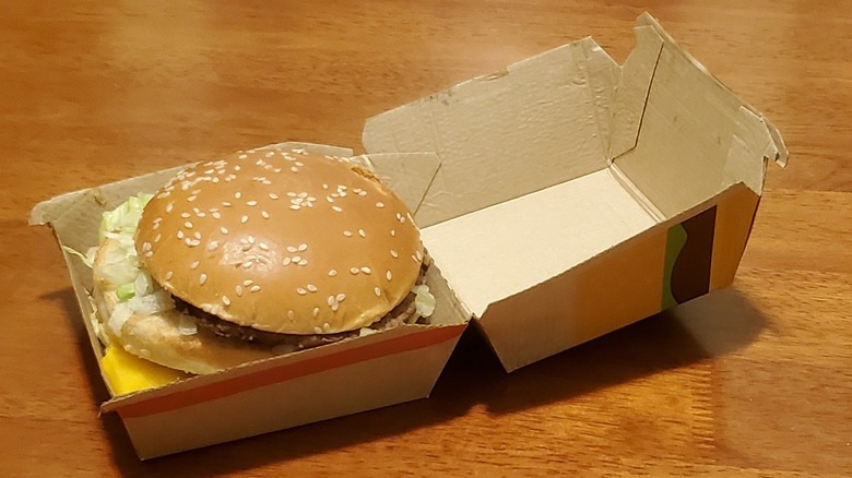 a McDonald's Big Mac in an open takeout box on table