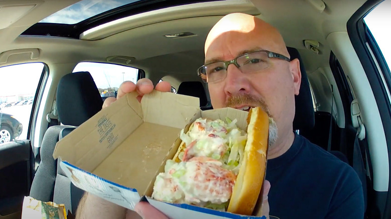 Reviewer with McDonald's lobster sandwich