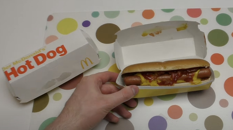 Person holding hot dog from McDonald's