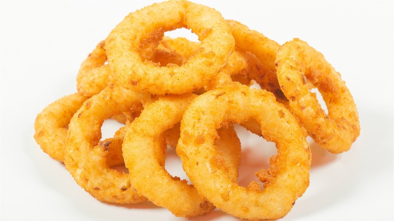 Pile of onion rings on cream background