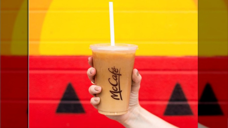 Hand holding McDonald's iced coffee