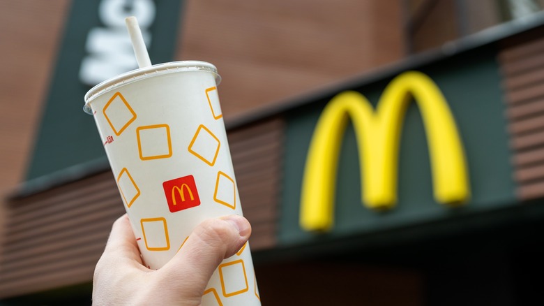 hand holding McDonald's drink