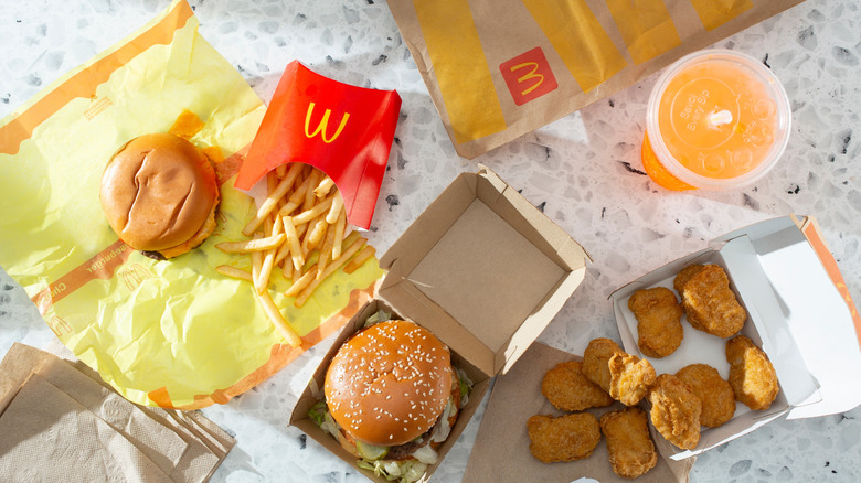 cheeseburger, fries, Big Mac, McNuggets and orange drink from a bird's eye view