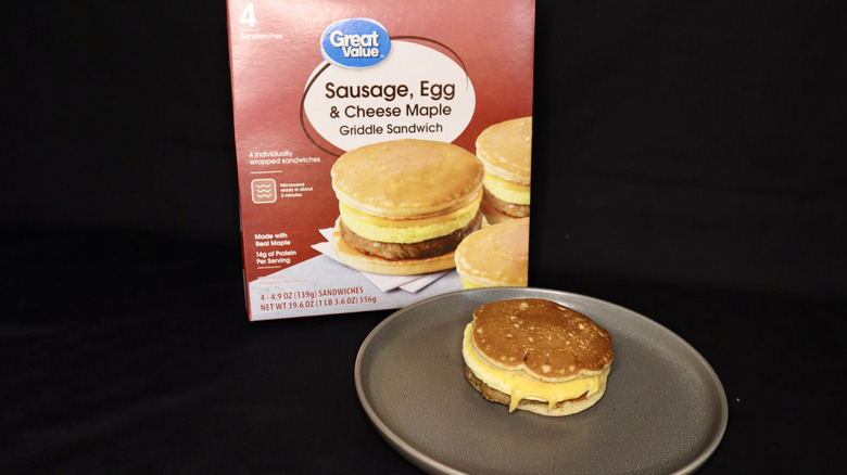 breakfast sandwich on plate in front of box