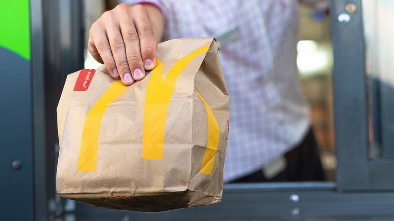 McDonald's worker handing over bag
