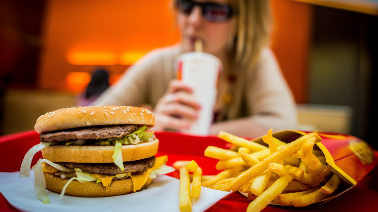 woman with big mac, fries, soda