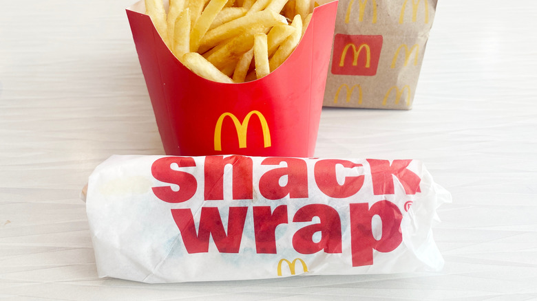 McDonald's snack wrap in packaging and french fries on a countertop