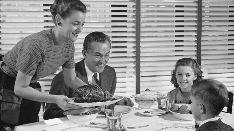 Black and white photo of a family having a meal together