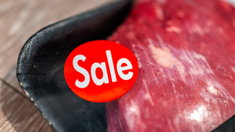 Meat with large sale sticker on package
