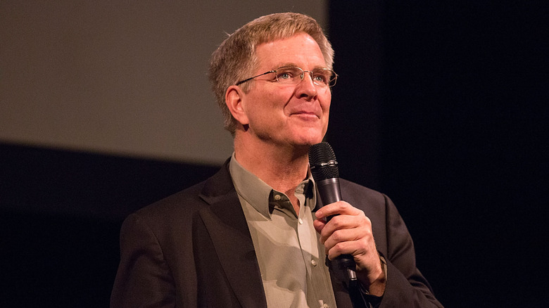 Rick Steves holding microphone