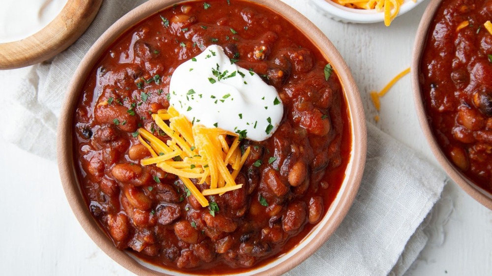 bowl of vegetarian goulash with cheese and sour cream