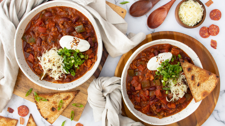 bowls with garnished meat chili 