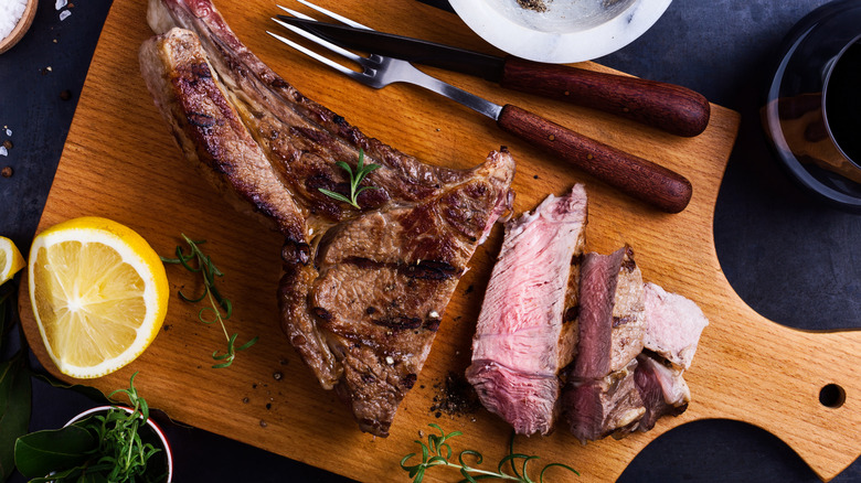 Sliced steak on wooden cutting board