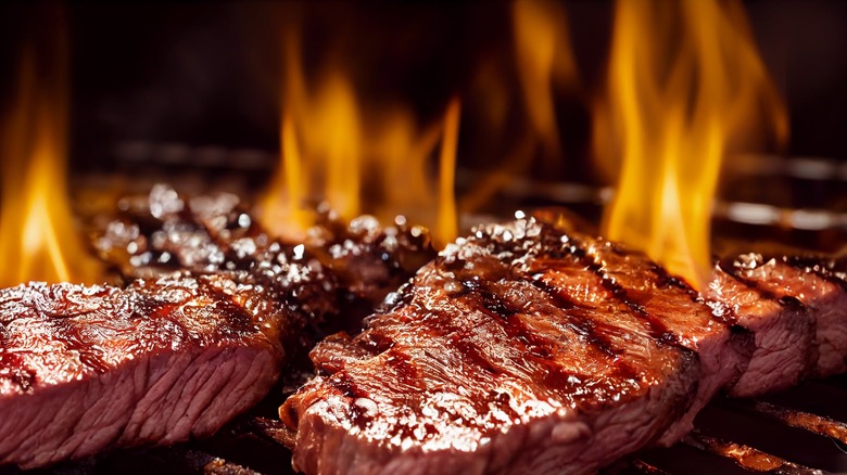 grilling steak with flame