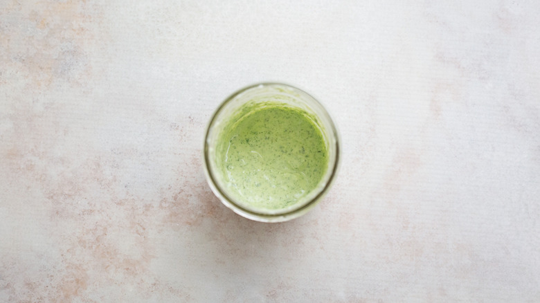 green herb sauce in jar