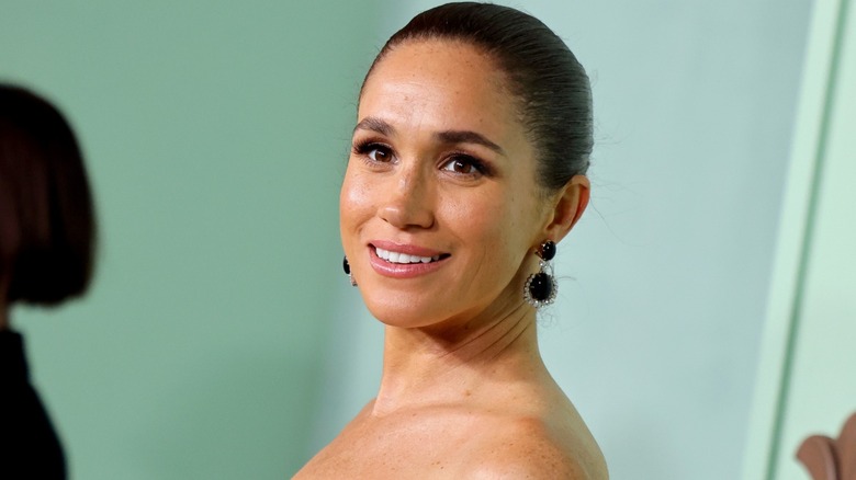 Meghan Markle smiling at a red carpet event