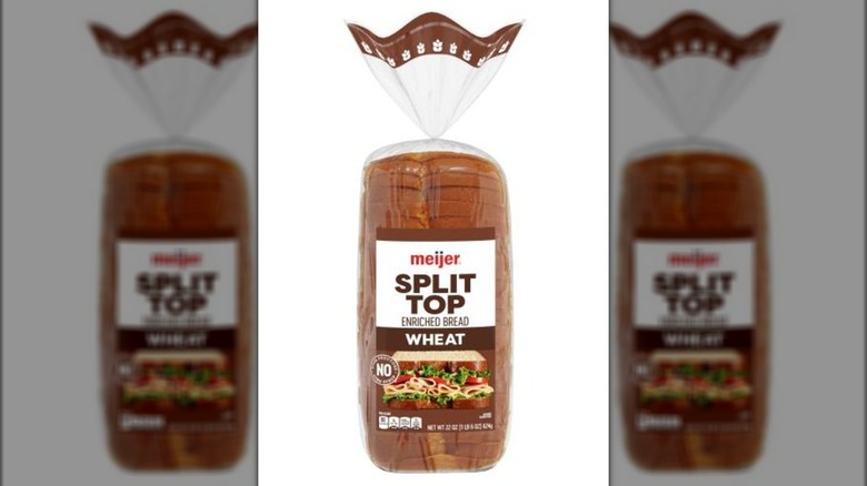 Loaf of split top wheat bread in plastic bag.