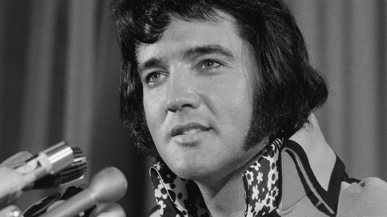 Elvis Presley smiling at a public event