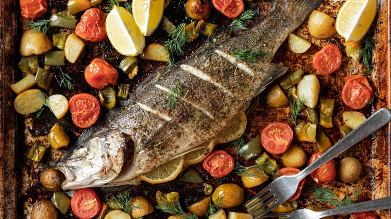 Sea bass with roasted potatoes, tomatoes, and green peppers