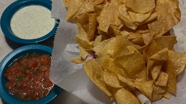 basket of chips, salsa and white sauce