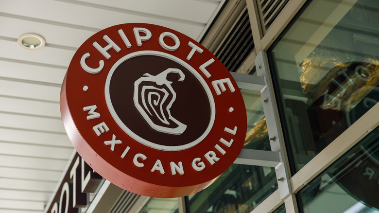 Chipotle sign on building exterior.