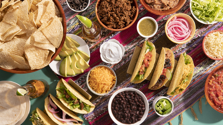 Spread of Mexican food with tacos and toppings