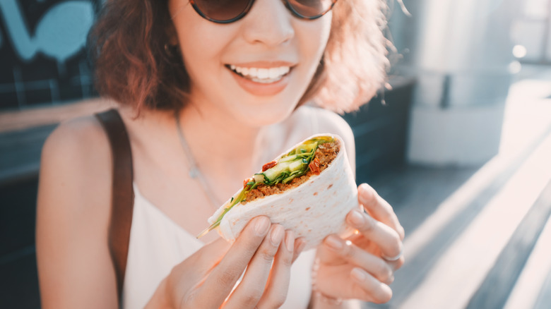 lady eating Mexican fast food