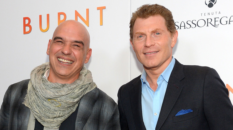 Michael Symon and Bobby Flay posing together