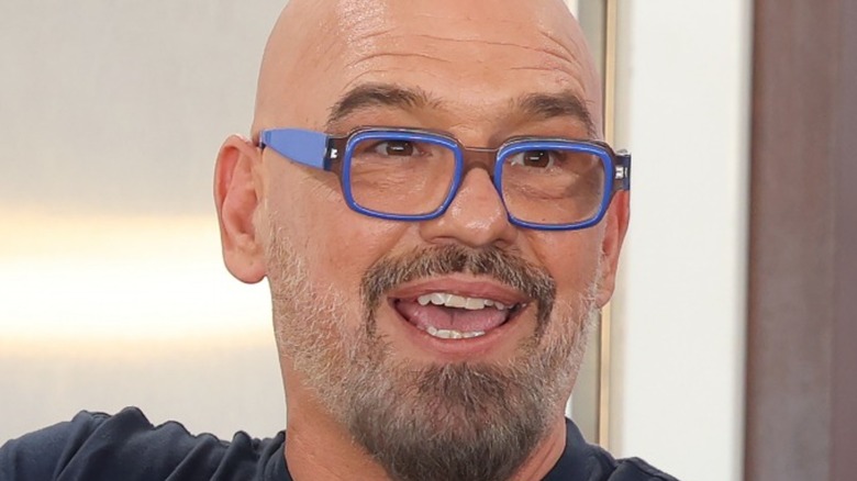 Close up of Michael Symon smiling wearing glasses