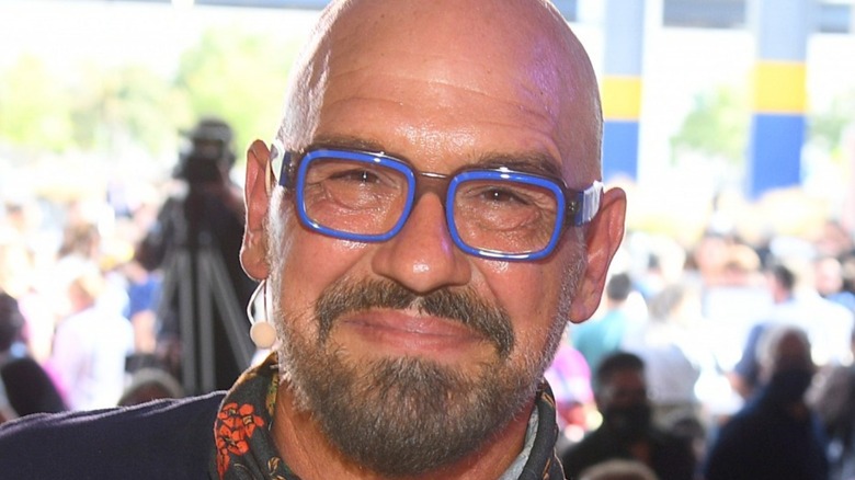 Michael Symon smiling wearing glasses