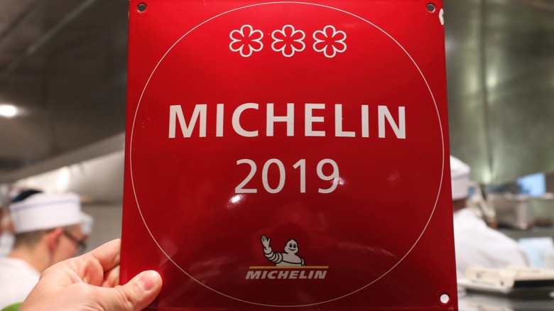 Person holding Michelin Star plaque