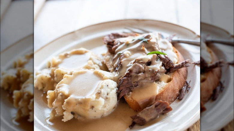 commercial hot beef sandwich on a white plate