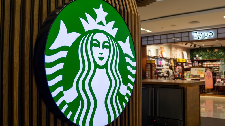 Starbucks mermaid logo on a shop exterior in a mall