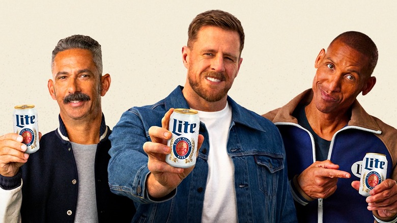 Three men holding beer cans