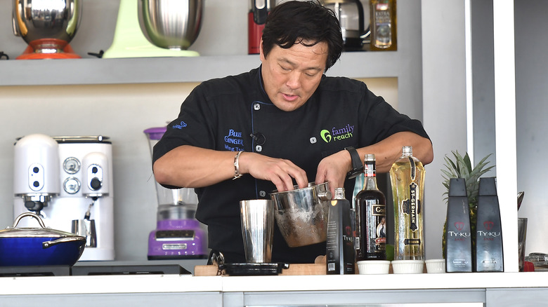 Ming Tsai cooking at a counter