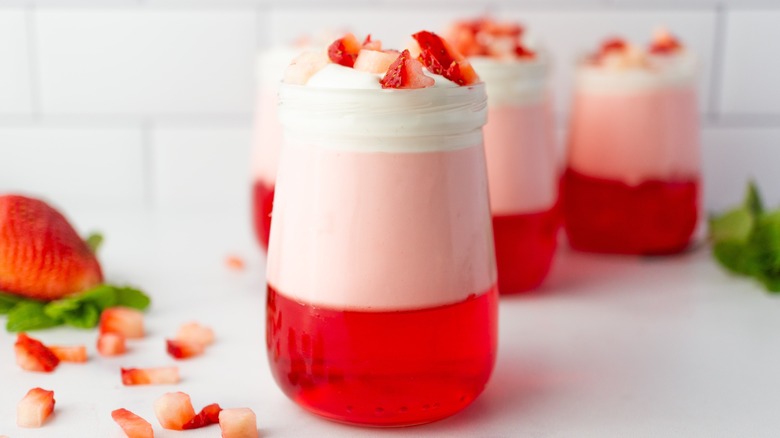 Strawberry jello parfaits sitting on a countertop