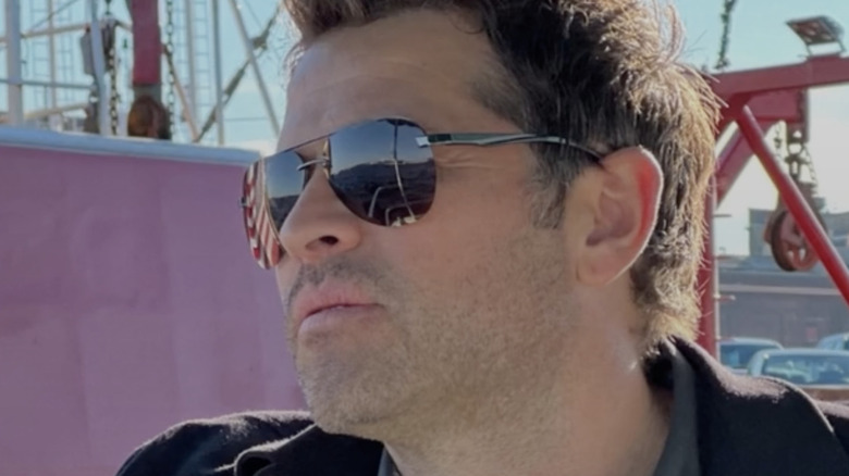 Collins wearing sunglasses on a ship