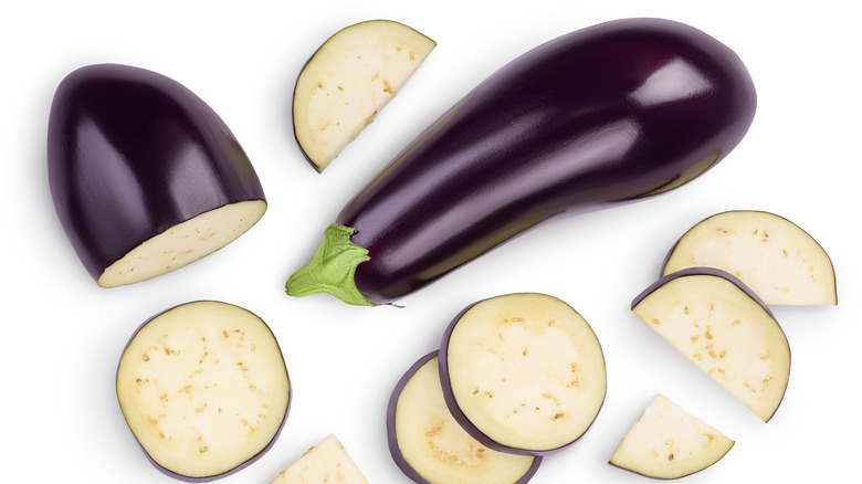 Eggplant and sliced eggplant on white backgrounds