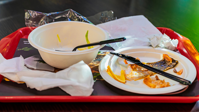 Messy tray on a table in a food court
