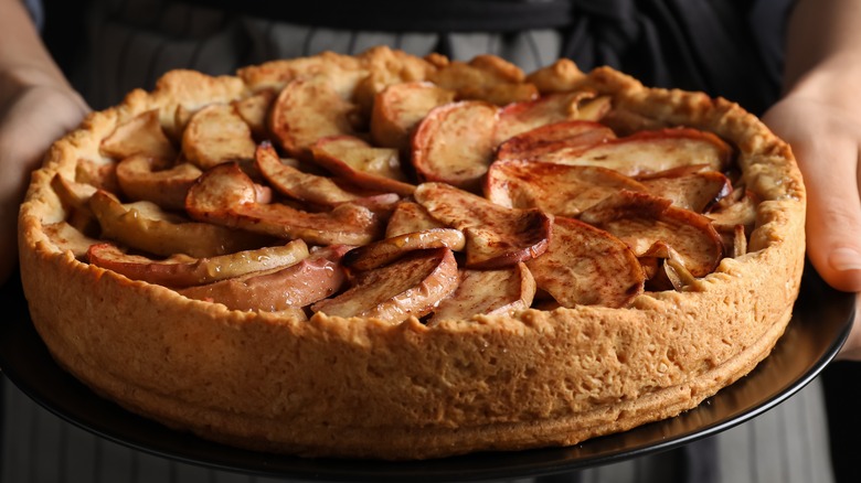 Woman holding an apple pie