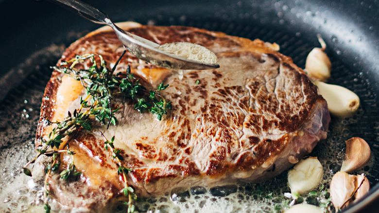 steak cooking in a pan