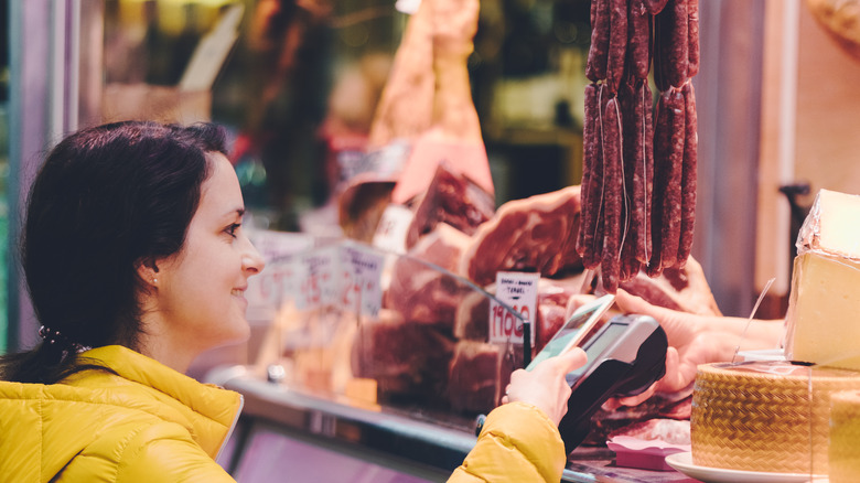 people buying sausage at counter