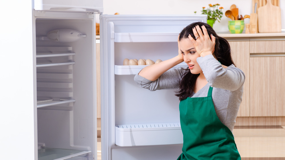 Woman cleaning a refrigerator