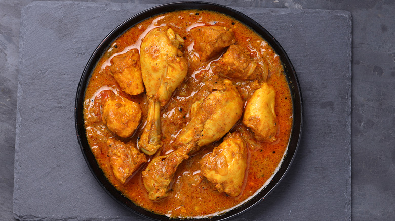 chicken curry in black bowl